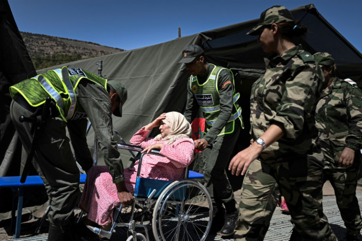 Members of Morocco's auxiliary forces attend to quake survivor in Asni