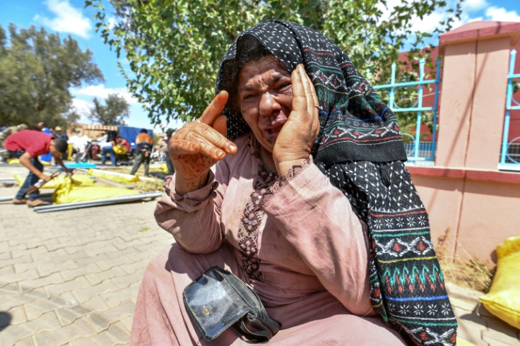 Quake survivor Fatima Oumalloul reacts after receiving a shelter tent