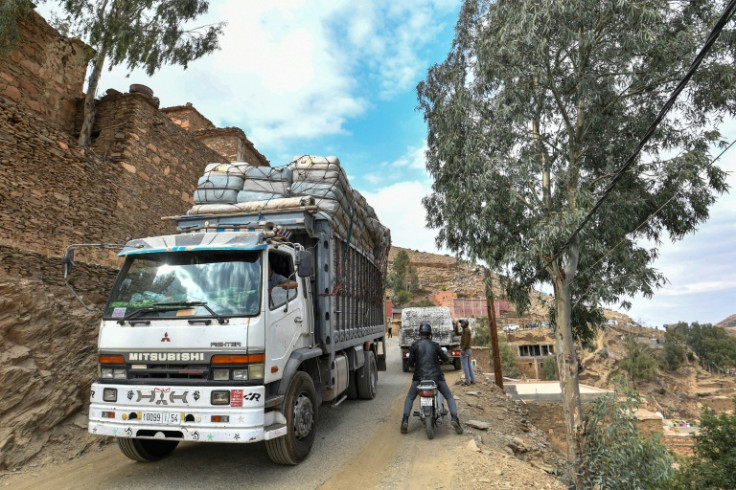 A truck carrying mattresses moves along a mountain road in the earthquake-hit village of Sidi Hassaine
