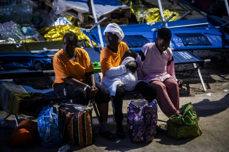 Migrants gather outside the operational centre called 'Hotspot'
