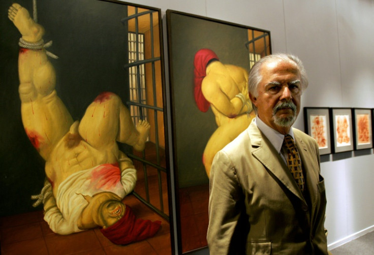 Fernando Botero poses in 2005 with one his paintings inspired by the abuse scandal at the US-run Abu Ghraib prison in Iraq
