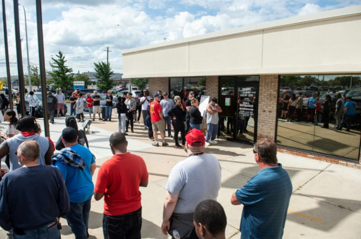 Members of the United Auto Workers (UAW) line up outside of the UAW Local 900 headquarters to sign up for strike funds