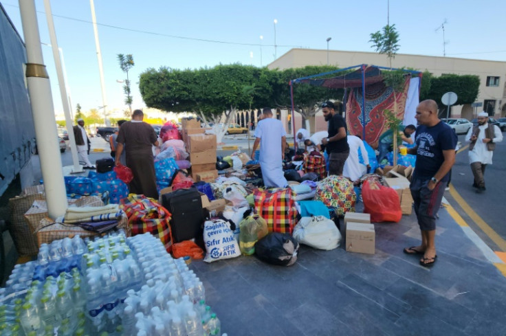 People bring donated supplies to a collection point in Libya's capital Tripoli