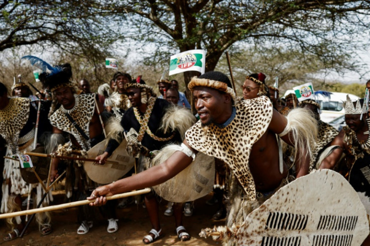 Men in Zulu warrior costume waited for hours to accompany Buthelezi's body to his homestead
