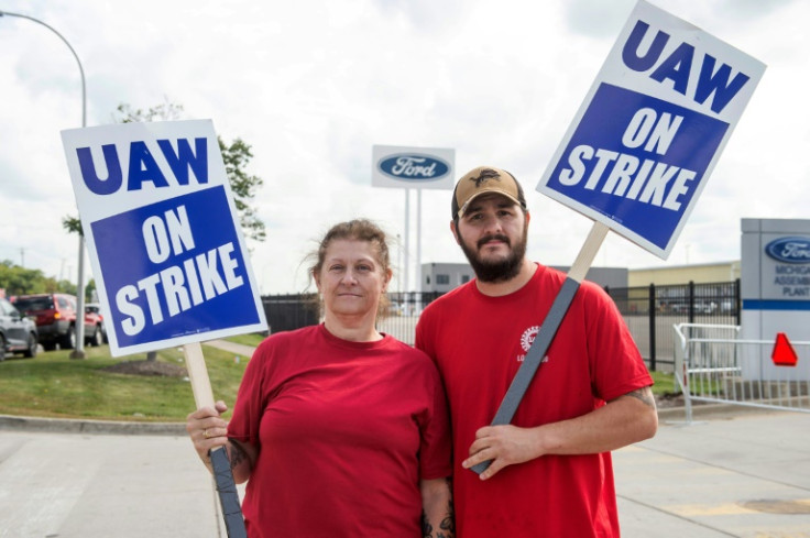 Ramona Jocys and her son-in-law Adam Gallup pose outside a Ford assembly plant on the first day of the United Auto Workers strike in Detroit, Michigan