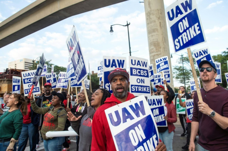 Blue Cross Blue Shield employees show their support to members of the United Auto Workers as they march through the streets of downtown Detroit following a rally on the first day of the UAW strike in Detroit, Michigan, on September 15, 2023