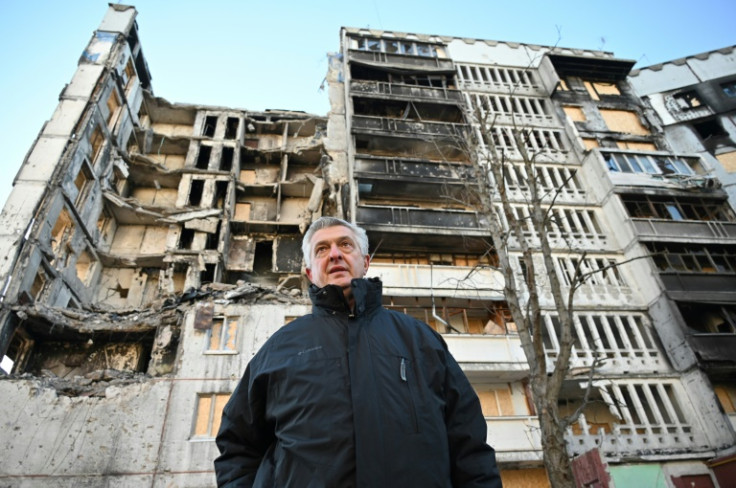 United Nations High Commissioner for Refugees Filippo Grandi examines buildings destroyed by shelling during a visit in the Ukrainian city of Kharkiv on January 24, 2023