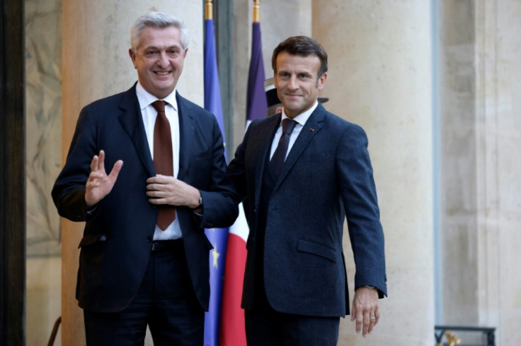 French President Emmanuel Macron greets United Nations High Commissioner for Refugees Filippo Grandi at the Elysee Palace on October 4, 2022
