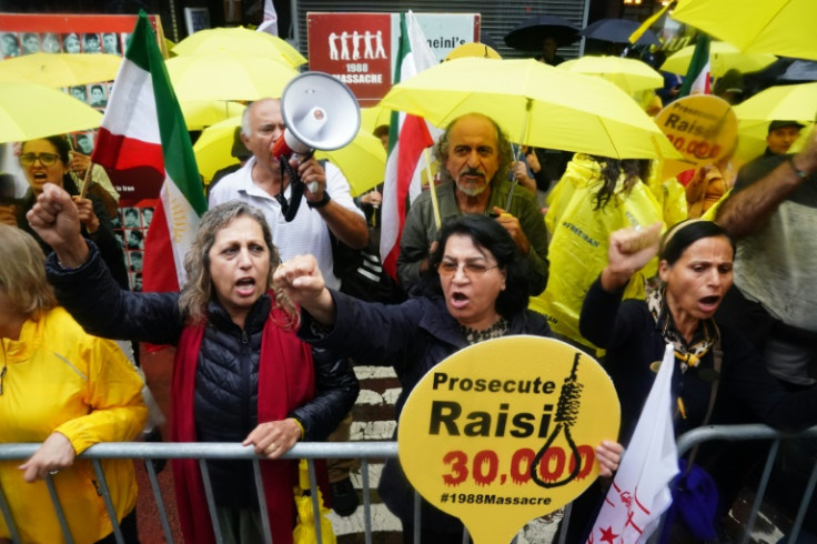 Iranian Americans hold signs and flags to protest Iranian President Ebrahim Raisi as he visits the United Nations