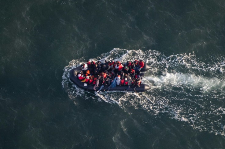 A French police aircraft photograph taken on Saturday shows migrants attempting to reach the English coast aboard an overcrowded dinghy