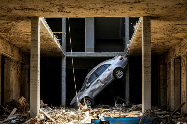 A tilted car sits above debris in Libya's eastern city of Derna