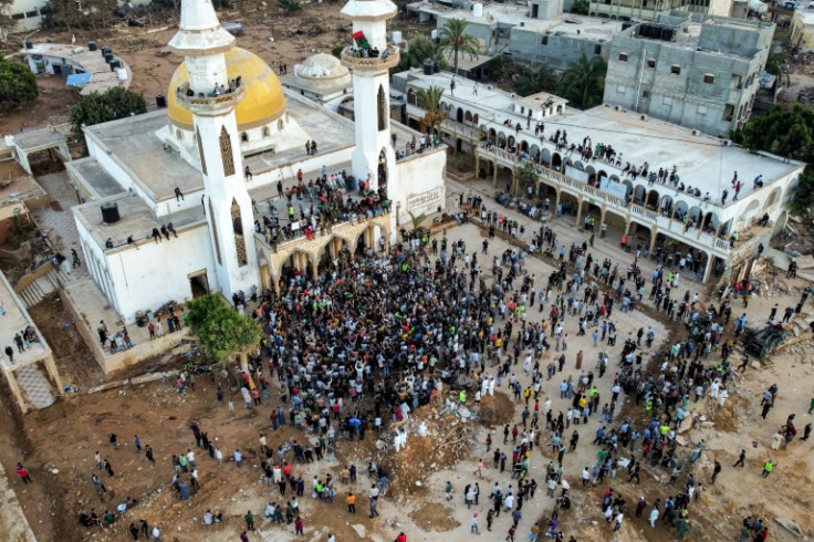 Protesters massed on Monday at the city's grand mosque, venting their anger at local and regional authorities they blamed for failing to maintain the dams or to provide early warning of the disaster