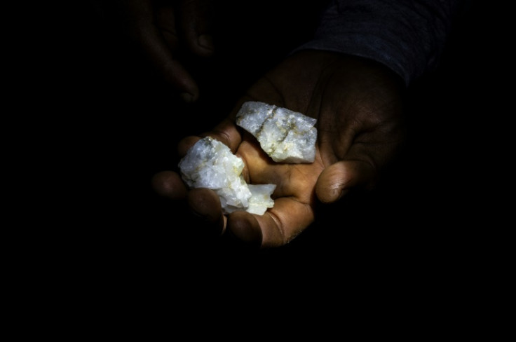 A Venezuelan miner shows rocks containing traces of gold that will later be processed by hand in a mill