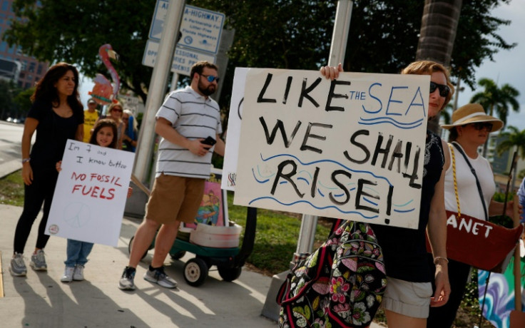 People take part in a solidarity march to end fossil fuels in Fort Lauderdale, Florida, on September 17, 2023