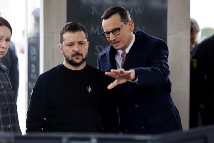 Ukrainian President Volodymyr Zelensky speaks with Polish Prime Minister Mateusz Morawiecki during a wreath-laying ceremony at Warsaw's Tomb of the Unknown Soldier in April 2023