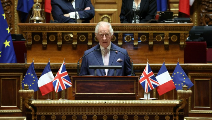 Charles spoke from a lectern adorned with EU, French and British flags