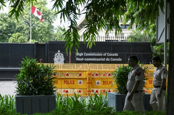 Security personnel stand guard in front of the High Commission of Canada in New Delhi
