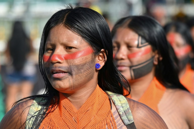 Brazilian Indigenous women celebrate after Brazil's Supreme Court ruled against efforts to restrict native peoples' rights to reservations on their ancestral lands in Brasilia on September 21, 2023.