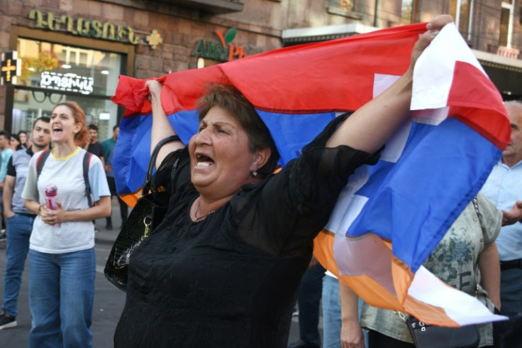 A woman holds a Karabakh flag at the rally in Yerevan