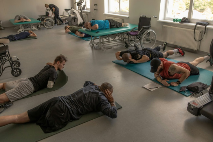 Wounded Ukrainian soldiers, most of whom have lost one or two limbs, attend a physiotherapy session