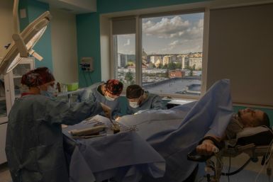 Surgeons at Nezlamny (Unbroken) clinic in the western city of Lviv perform surgery on a Ukrainian soldier who lost his leg last year