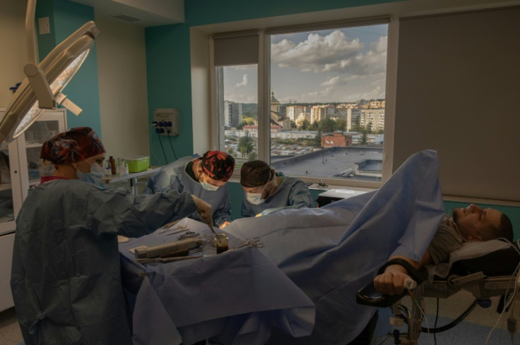 Surgeons at Nezlamny (Unbroken) clinic in the western city of Lviv perform surgery on a Ukrainian soldier who lost his leg last year