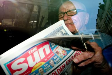 Rupert Murdoch in 2012 with a copy of the newly launched 'The Sun on Sunday' newspaper which replaced the scandal-hit 'News of the World'
