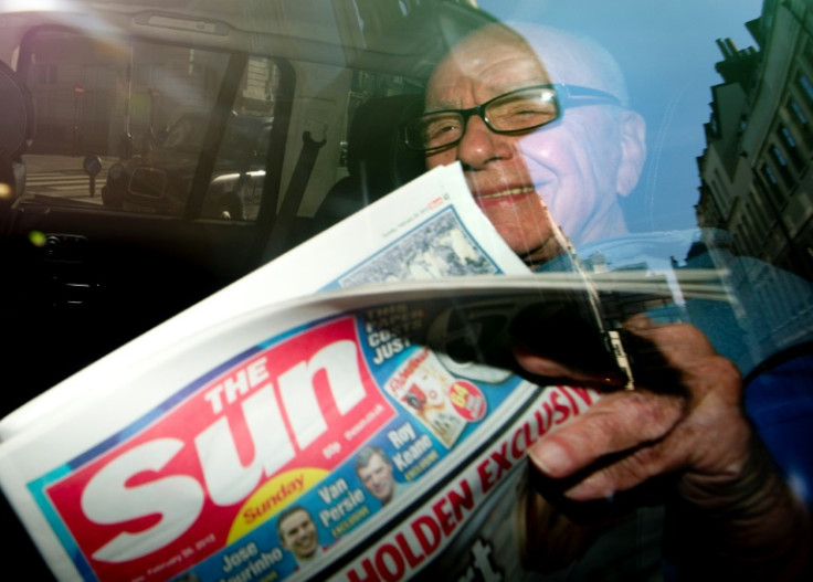 Rupert Murdoch in 2012 with a copy of the newly launched 'The Sun on Sunday' newspaper which replaced the scandal-hit 'News of the World'