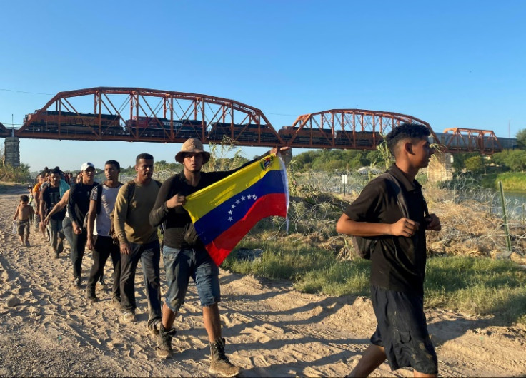 Jesus Ramirez, a 29-year-old migrant, waves a Venezuelan flag as he arrives on US territory in Texas