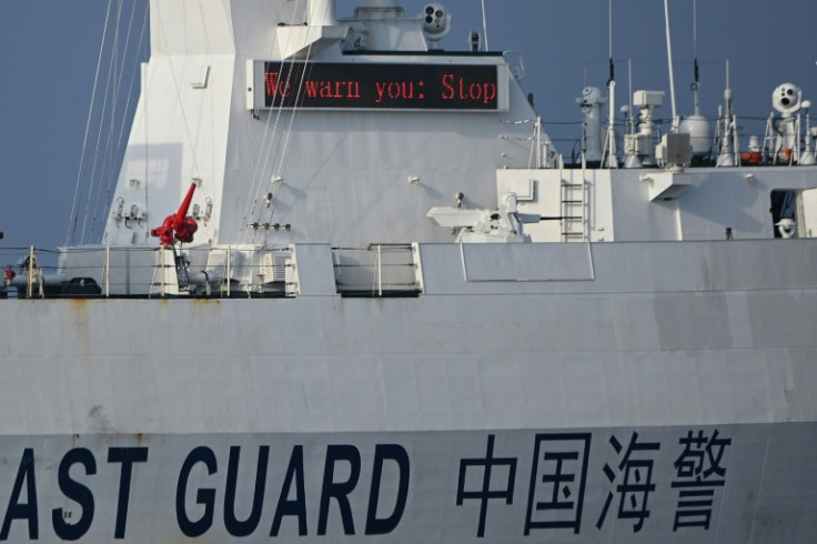 A Chinese coast guard ship sends a warning on a digital message board to a Philippine Bureau of Fisheries and Aquatic Resources' ship near the Scarborough Shoal