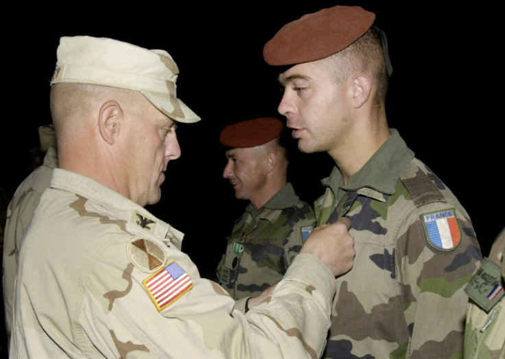 Mark Milley, a colonel at the time, awards a medal to a French soldier in Afghanistan in October 2003