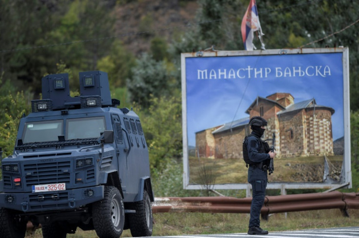 Kosovo police officers stand guard around the entrance to the village of Banjska, northern Kosovo