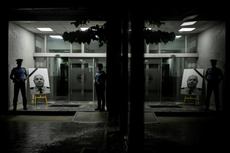 Portraits of Kosovo police officer Afrim Bunjaku, who was killed by armed gunmen in the village of Banjska near the border with Serbia, are displayed outside the police station in Pristina