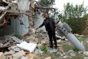 Azeri Javid Ismayilov next to a missile that destroyed his house during the 2020 war