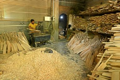 A worker crafts a Kashmiri willow wood cricket bat at a factory in Kashmir's Sangam village, on August 19, 2023