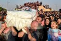 A large crowd gathered at the cemetery in Qaraqosh, parting to make way for coffins