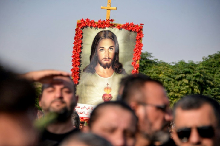 Around 20 coffins covered in satin or bouquets of flowers were carried through the crowd on the shoulders of men