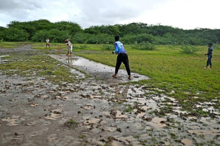 Children play cricket at what is believed to be India's first pitch, in Tankari Bandar village