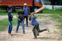 Children play cricket in Jambusar town in India's western state of Gujarat