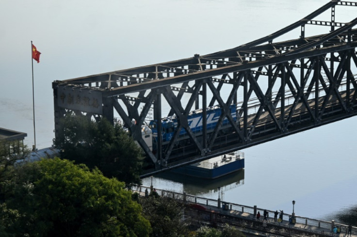 A commercial train passes on the Friendship Bridge that connects the North Korean town of Sinuiju and the Chinese city of Dandong
