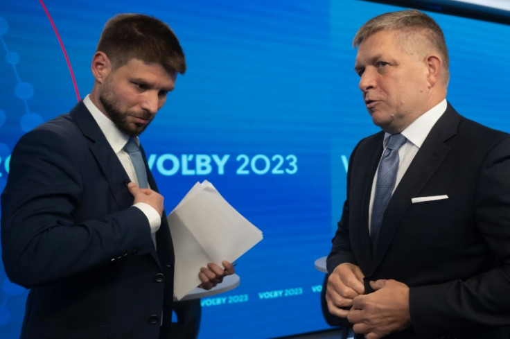 The Progressive Slovakia party's Michal Simecka (l) and Smer-SD leader Robert Fico chat after a televised electoral debate this week