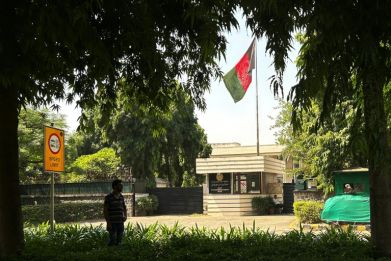 The flag of the previous Afghanistan republic flies over the entrance to the embassy in the Indian capital, New Delhi