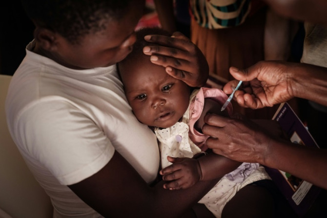 A child in Kenya receives a shot of the first approved malaria vaccine earlier this year