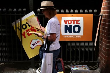 A volunteer hands out voting brochures outside a voting centre in central Sydney on October 3, 2023. Early voting opened on October 3 across a swathe of Australia on a reform that would recognise Indigenous people in the 1901 constitution for the first ti