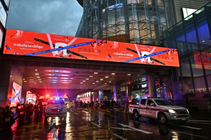 Ambulances and police vehicles are seen outside Siam Paragon shopping centre in Bangkok following a shooting incident in the mall