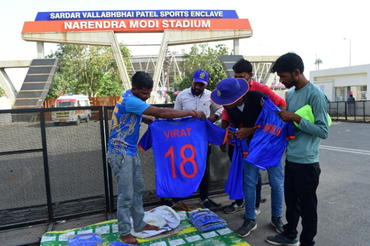 Selling point: Fans buy replica shirts outside Ahmedabad's Narendra Modi stadium ahead of Thursday's opening match of the World Cup