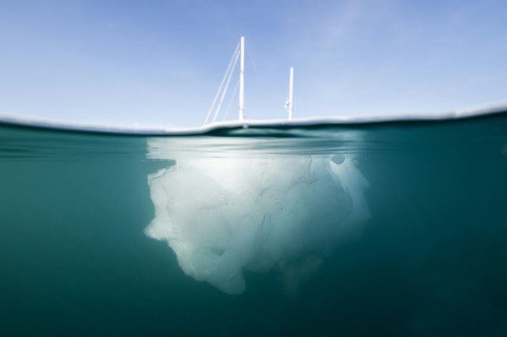 The French scientific expedition vessel "Kamak" behind a melting iceberg in Greenland's in Scoresby Sound