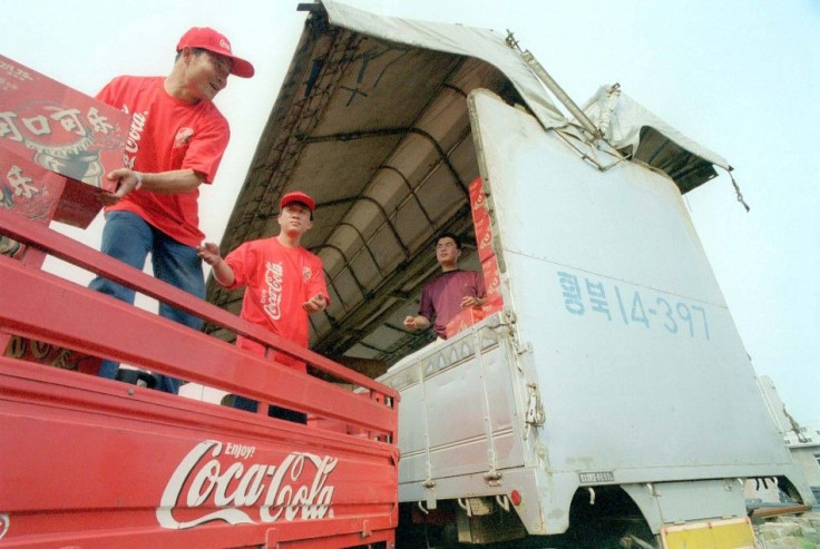 CHINESE TRUCKERS LOAD UP COCA COLA FOR NORTH KOREA.