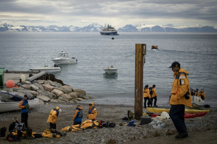 Cruise ship tourists leave Ittoqqortoormiit after visiting the Inuit village
