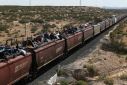 More than a thousand migrants rode atop a freight train to the edge of the US border